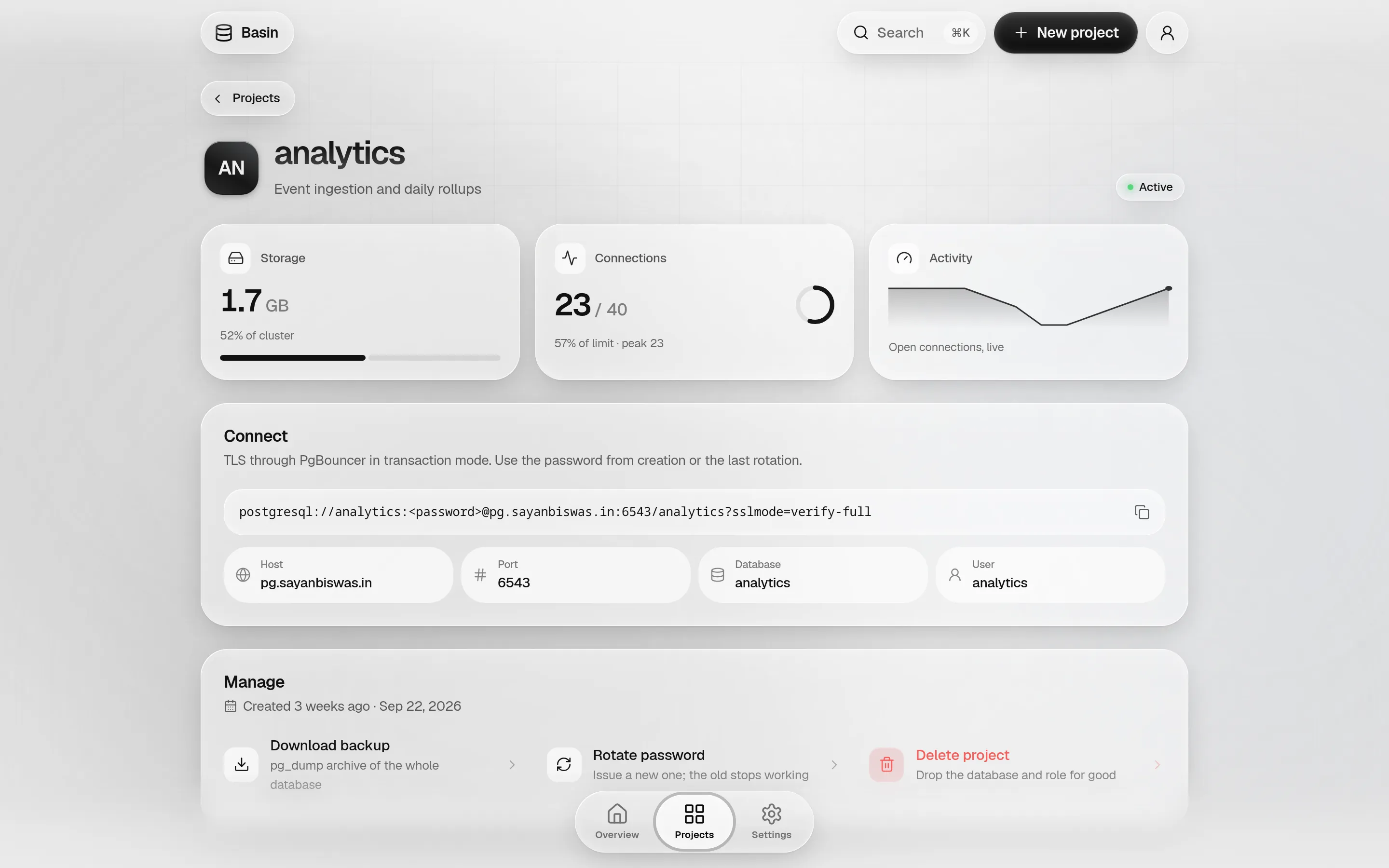 The analytics project page: 1.7 GB of storage at 52% of the cluster, 21 of 40 connections with a ring, a live activity chart, the connection string, and backup, rotate and delete actions.
